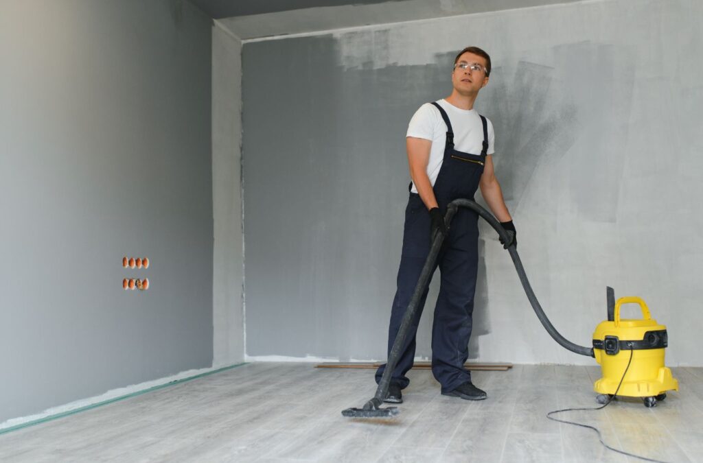 A Honeycomb Home Cleaning technician meticulously cleaning a recently constructed space in Oxnard, CA, highlighting the benefits of hiring local professionals for post construction cleaning.