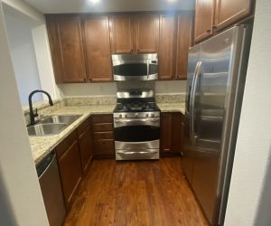 Skilled Honeycomb cleaner efficiently organizing and cleaning a living space in Santa Clarita, providing peace of mind to homeowners